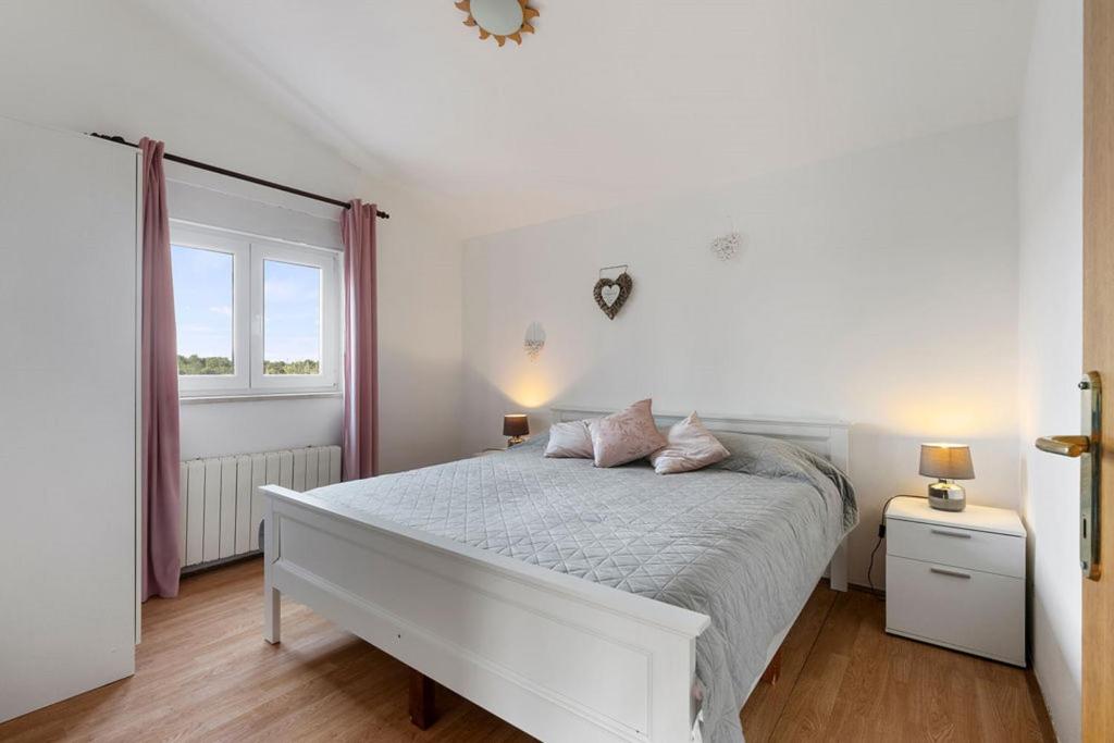 Łóżko lub łóżka w pokoju w obiekcie Apartments Erla