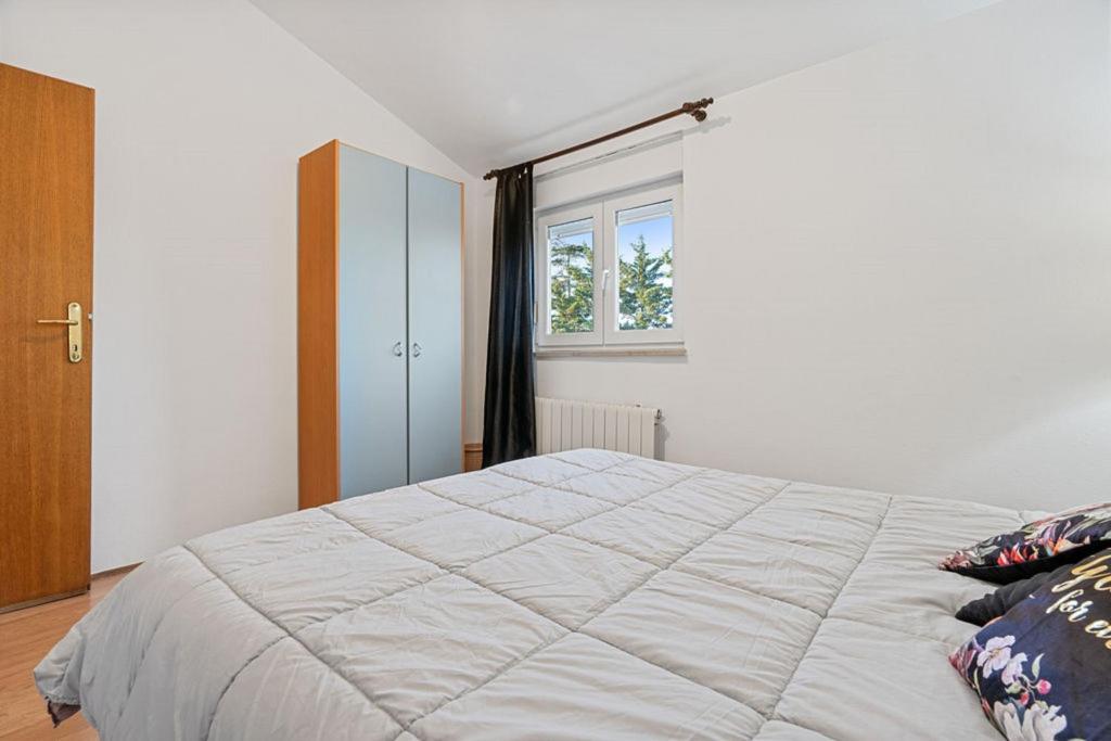 Łóżko lub łóżka w pokoju w obiekcie Apartments Erla