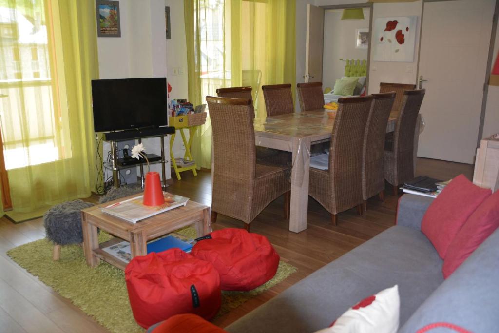 a living room with a table and a couch at Appartement Bois de Marie in Sers