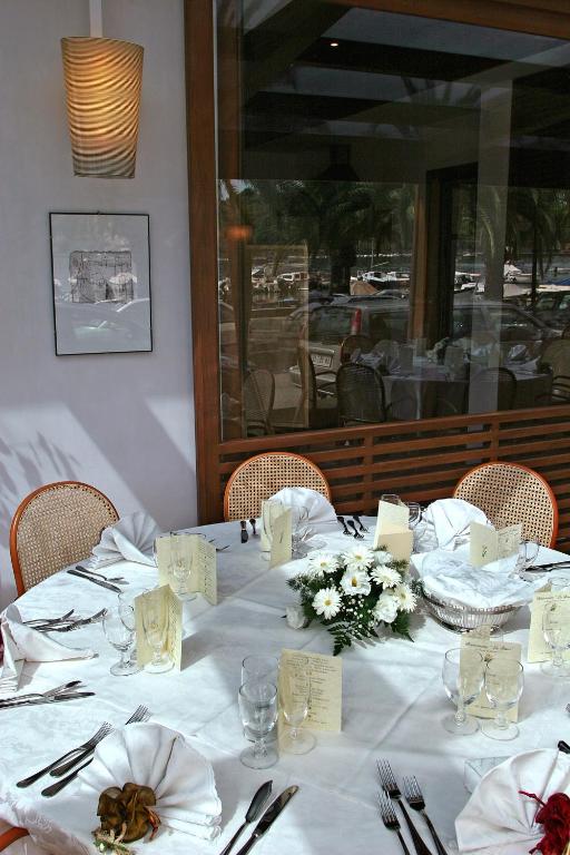 a table in a restaurant with a white table cloth at Hotel Della Baia in Portovenere