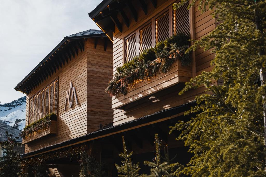 a building with plants on the side of it at The Mountains Hotel in Sierra Nevada