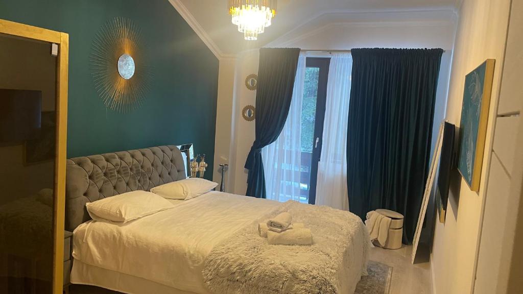 a bedroom with a large bed with a mirror at Velvet by Poiana Brasov in Poiana Brasov