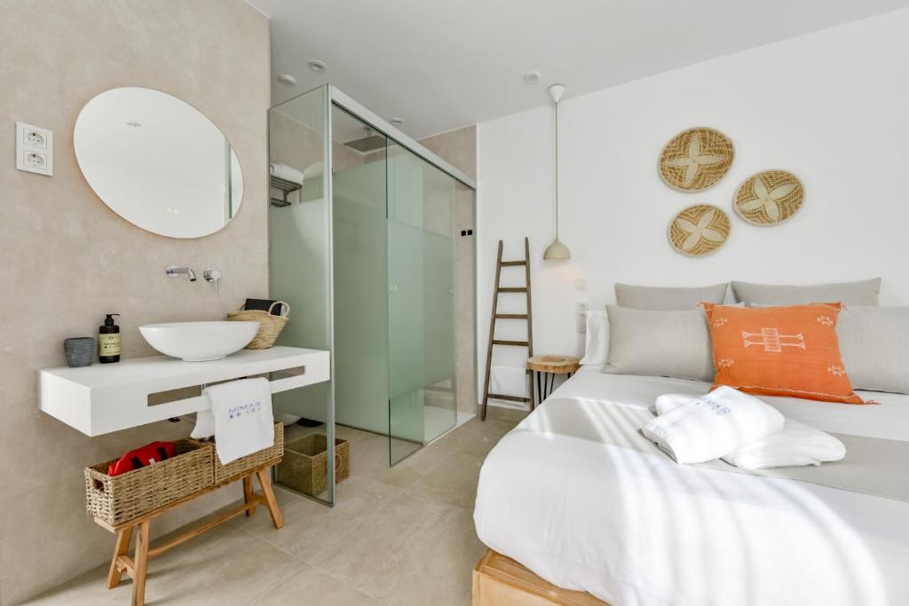 a bedroom with a bed and a sink and a mirror at MIMAR ALTEA ROOMS - Tranquil in Altea