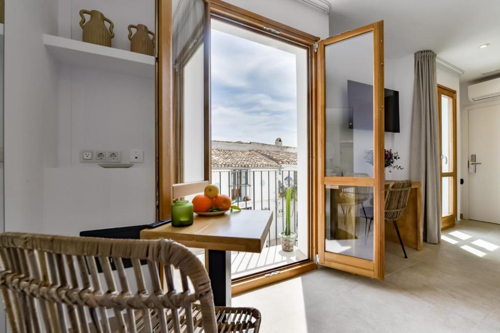 a dining room with a table and a window at MIMAR ALTEA ROOMS - Tranquil in Altea