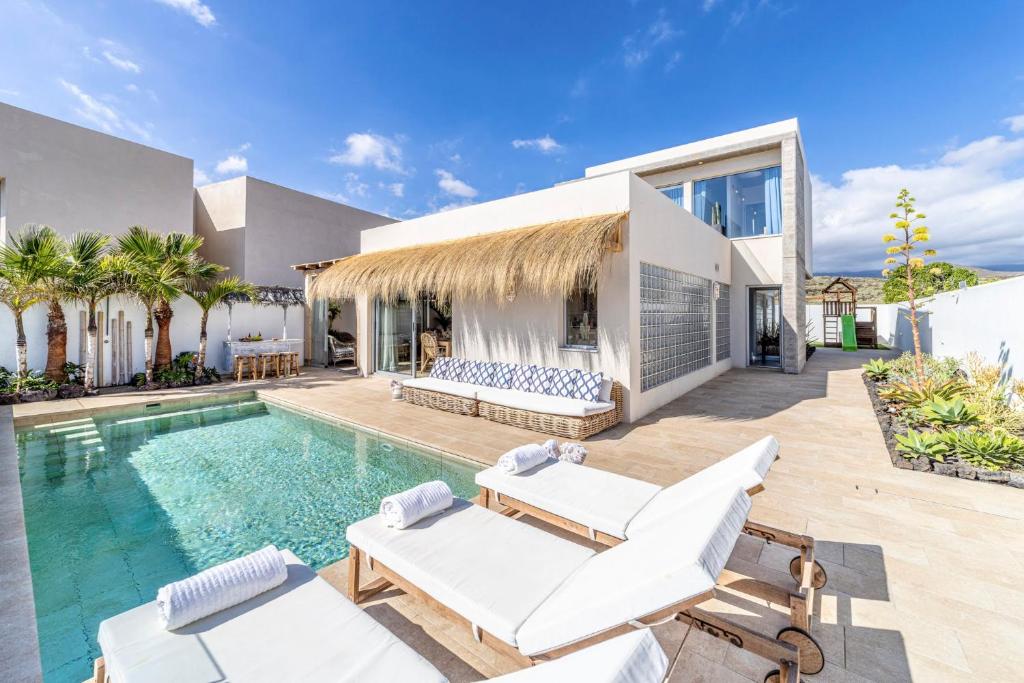 a villa with a swimming pool and a house at Ixchel Beach House By Sunkeyrents in El Médano