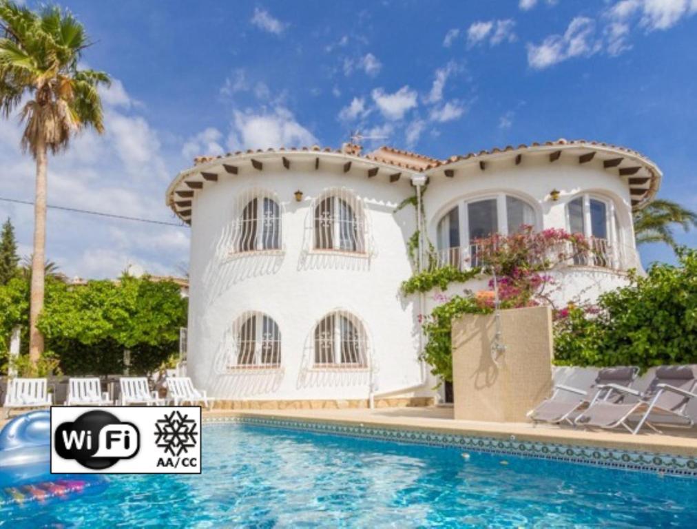 a villa with a swimming pool in front of a house at AT060 Villa Ortenbach in Ifach