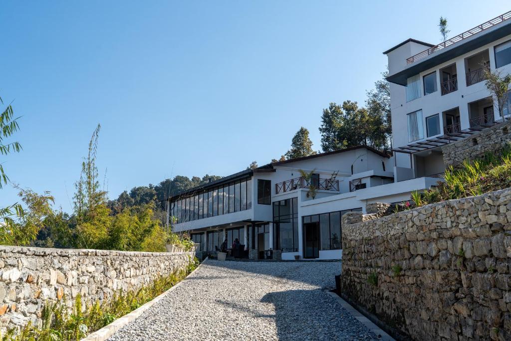 a house on a hill with a stone wall at Nana Mountain Resort Mt Annapurna View in Kāskī