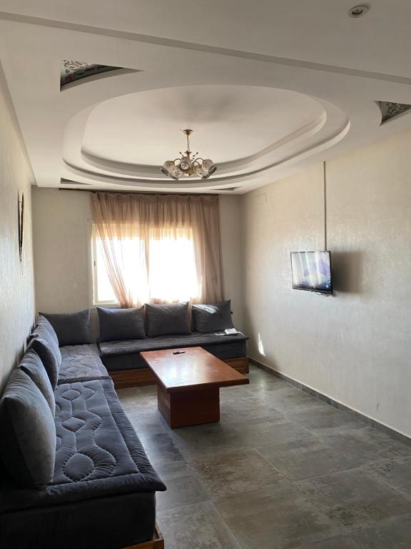 a living room with a couch and a table at The Little Royal Mansour 2 in Agadir