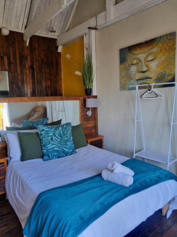 a bedroom with a large bed with blue pillows at Yello Hotel in Strand