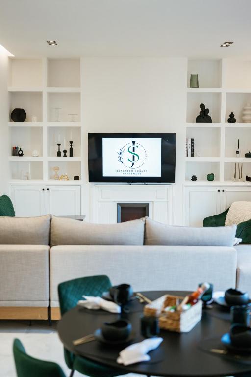a living room with a couch and a table at SeaGreen Luxury Apartment in Alexandroupoli