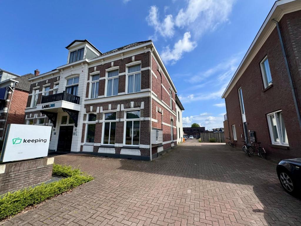an empty street in front of a brick building at 86 1 City Appartement in Enschede