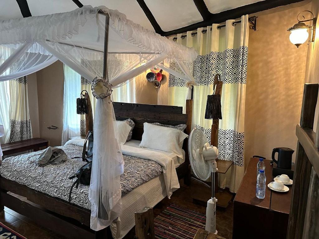 Postel nebo postele na pokoji v ubytování Selous Kinga Lodge