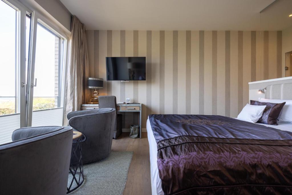 Postel nebo postele na pokoji v ubytování Hotel STRAND am Königshafen