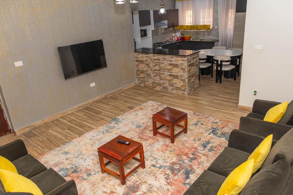 a living room with a couch and a table at Urban Bliss Residence in Bungoma