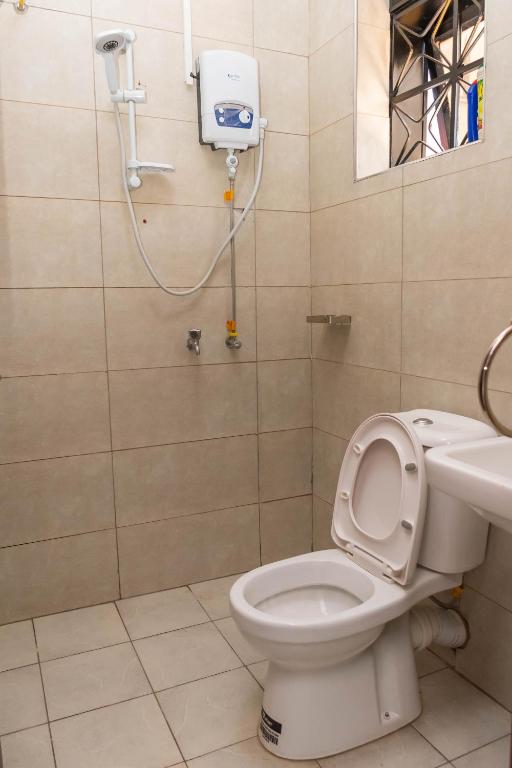 a bathroom with a toilet and a sink at Urban Bliss Residence in Bungoma