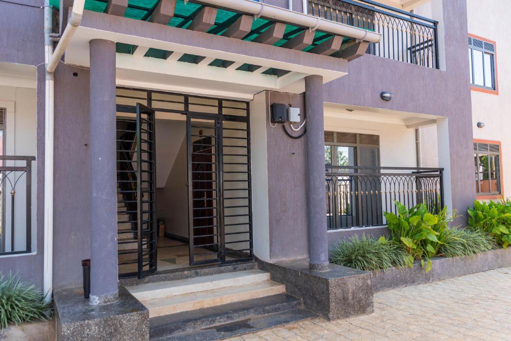 a building with a door with a balcony at Urban Bliss Residence in Bungoma