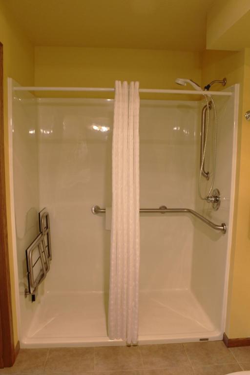 a white shower with a shower curtain in a bathroom at 2 Bedroom Accessible condo, #114 Wild Eagle Lodge in Eagle River