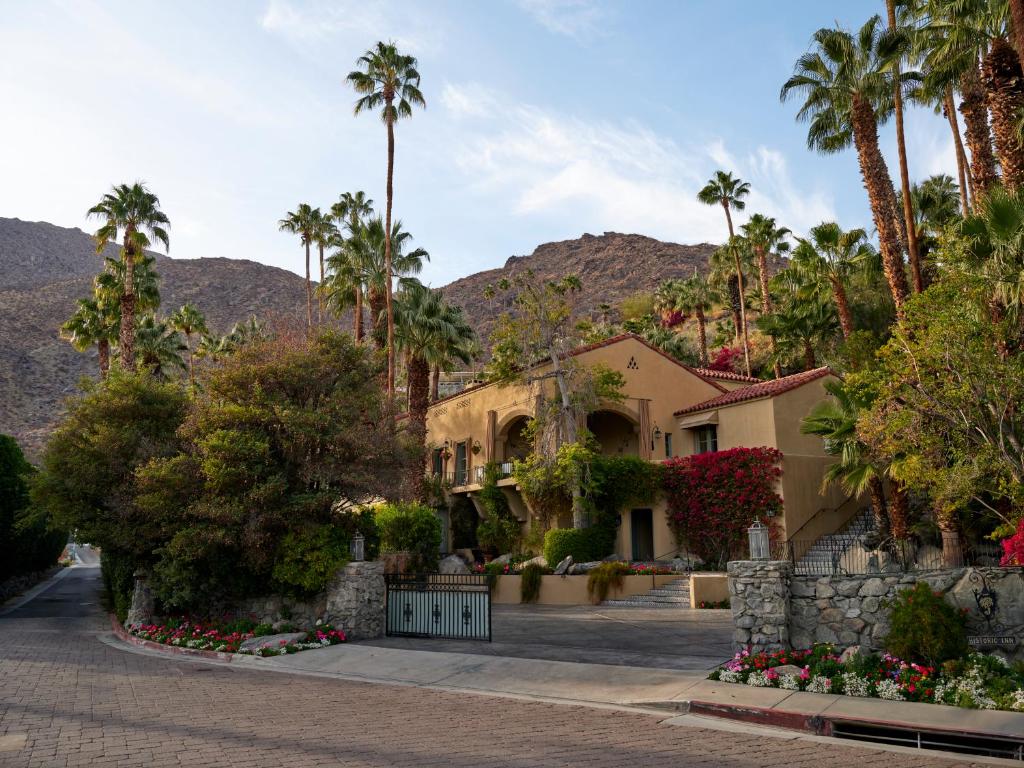 a house in the desert with palm trees at The Willows Palm Springs in Palm Springs