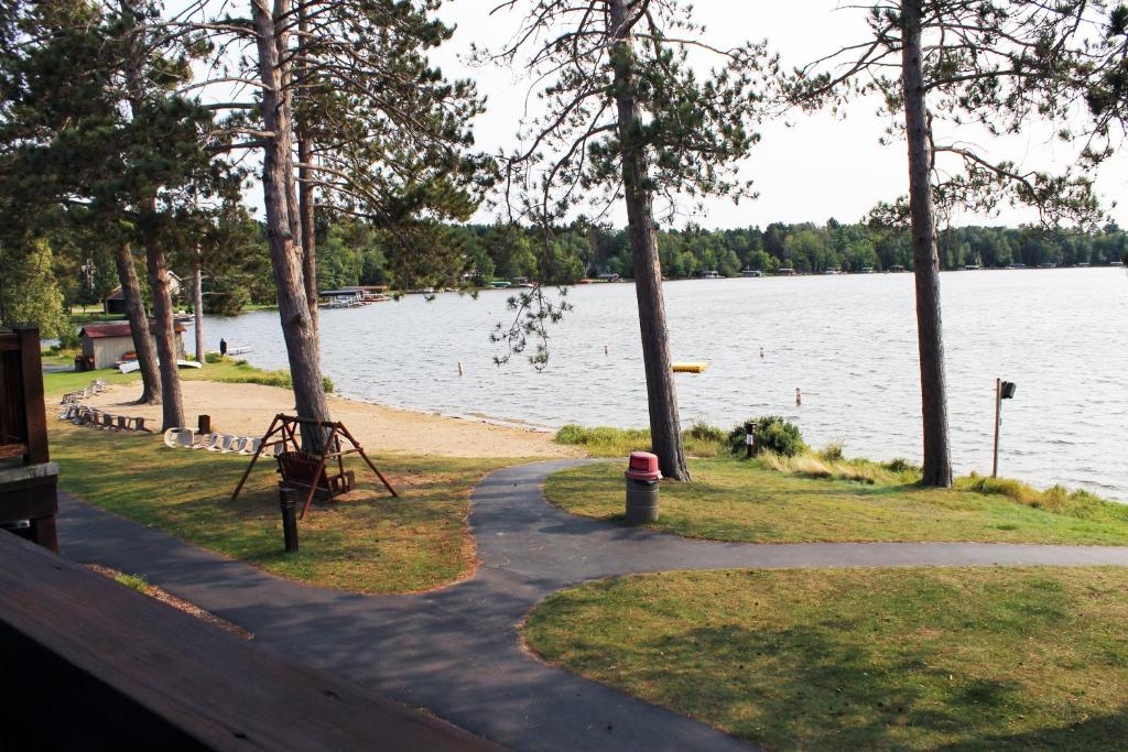 a path next to a body of water with trees at Wild Eagle Lodge, 2 bedroom 2nd floor condo, #216 in Eagle River