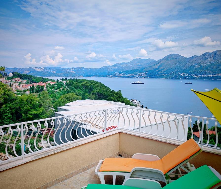 a balcony with chairs and a view of a lake at Villa Stanović Tea in Cavtat
