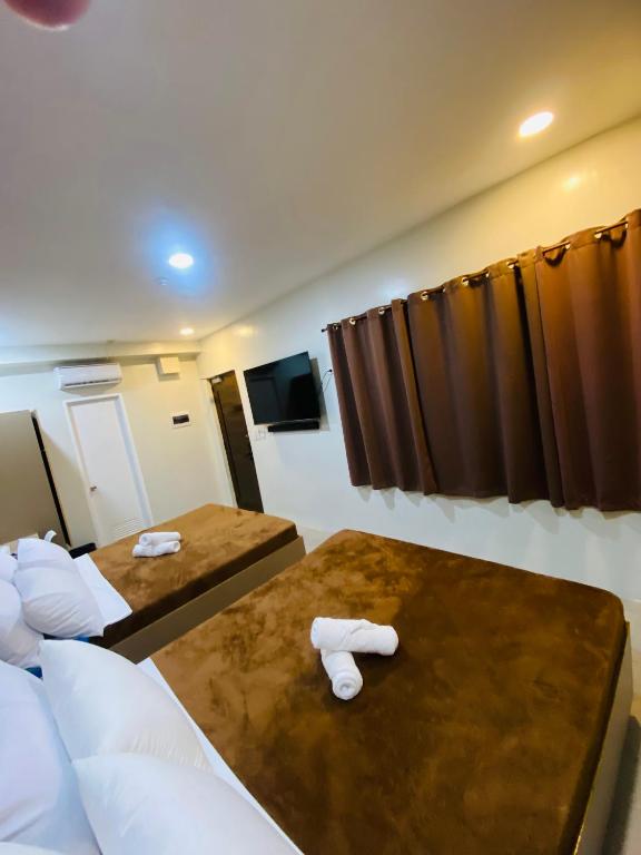 Postel nebo postele na pokoji v ubytování ZenSuites Hotel Tacloban
