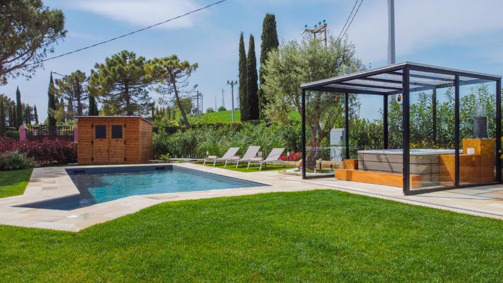 a swimming pool in a yard with a gazebo at L'Organetto - Villa with Private Pool in Lido di Fermo
