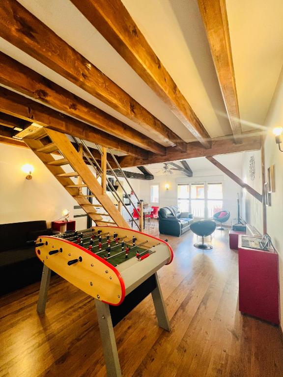 a living room with a surfboard on a table at Le Kassin in Tallard