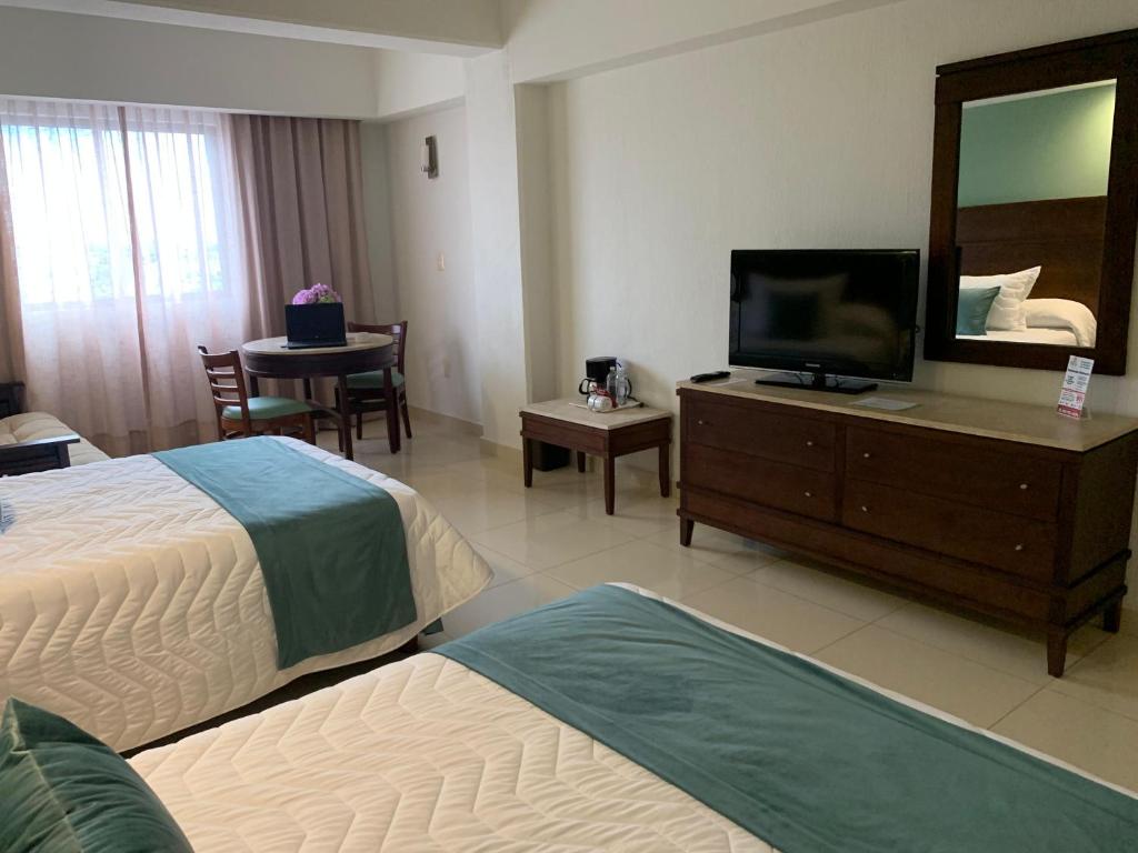 Postel nebo postele na pokoji v ubytování Hotel Bello Veracruz