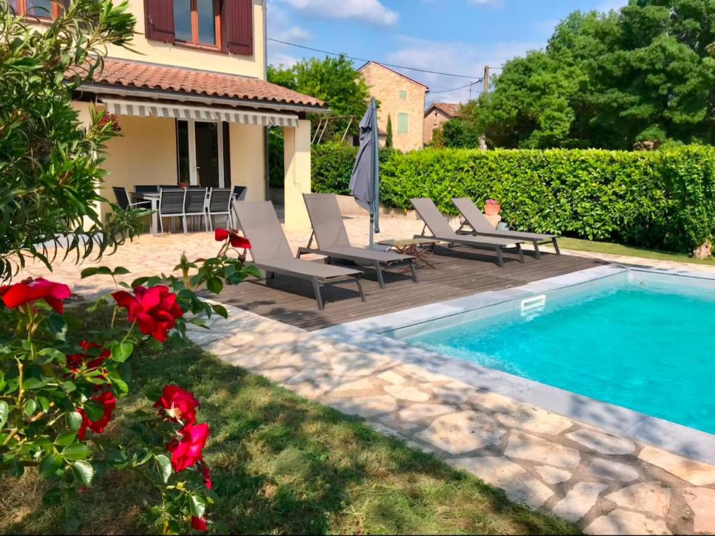 une arrière-cour avec une piscine, des chaises et une maison dans l'établissement Maison de Charme Sud Ardèche, à Vallon-Pont-dʼArc