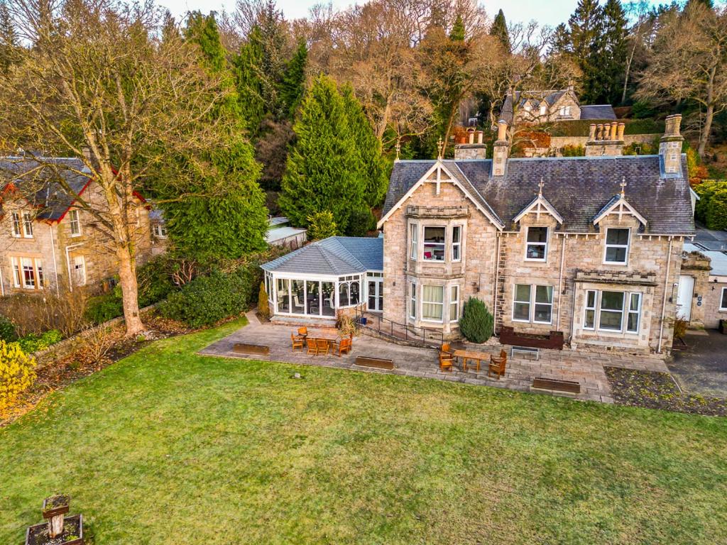 an aerial view of a large stone house at Claymore Apartments in Pitlochry