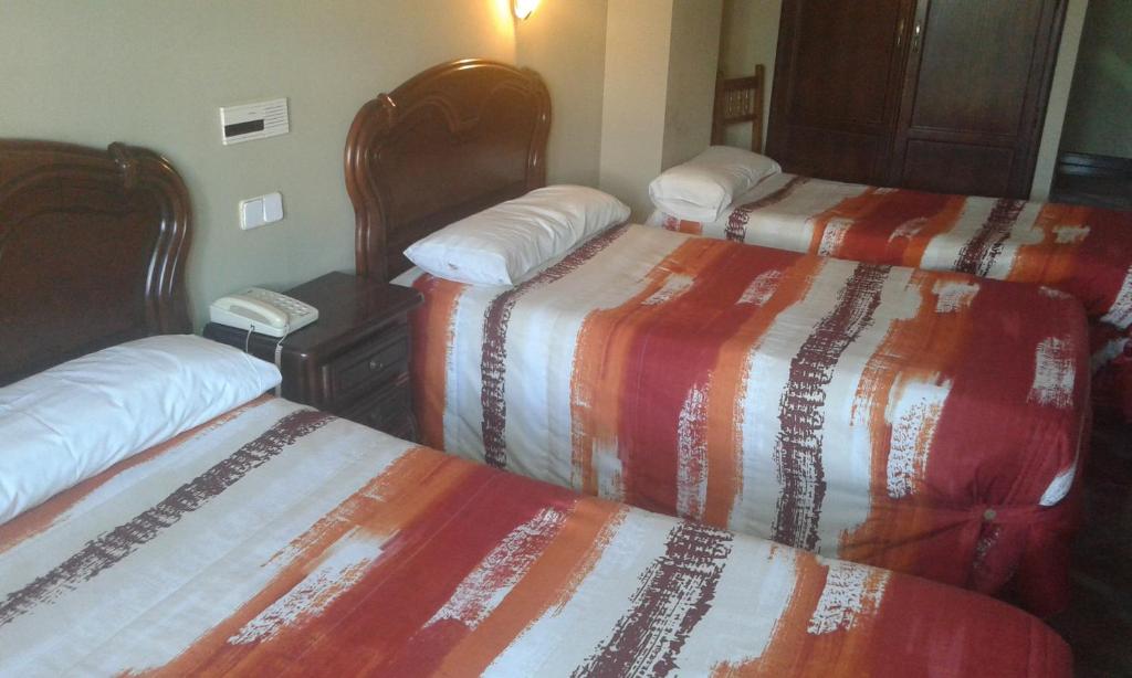 Postel nebo postele na pokoji v ubytování Hotel Casa Aurelia