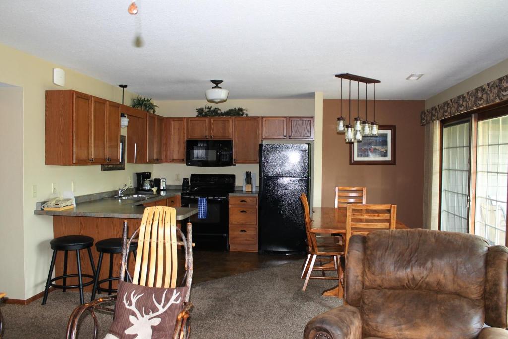 a kitchen and dining room with a table and chairs at 2 Bedroom Condo at Wild Eagle Lodge, #136 in Eagle River