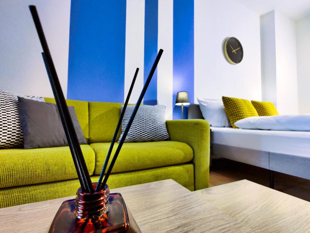 a living room with a couch and a table at Modernes City-Apartment nahe der Elbe mit Terrasse in Magdeburg