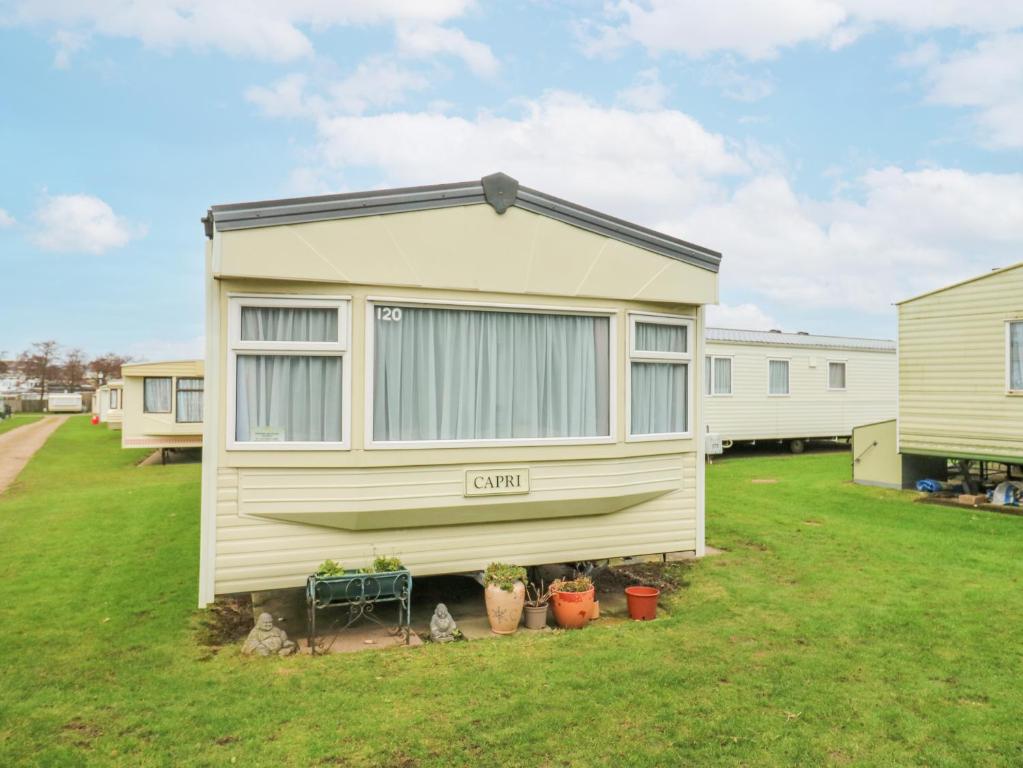 a tiny house is parked in a yard at 120 Caravan in Great Yarmouth
