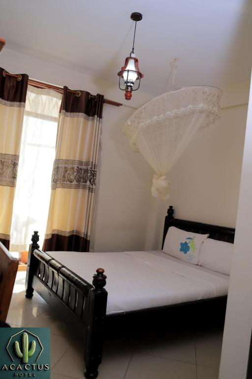 Postel nebo postele na pokoji v ubytování Acactus Hotel