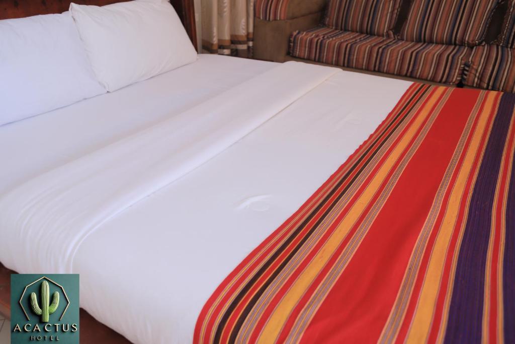 Postel nebo postele na pokoji v ubytování Acactus Hotel