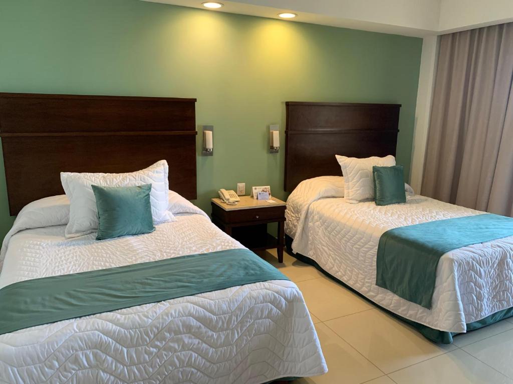 Postel nebo postele na pokoji v ubytování Hotel Bello Veracruz