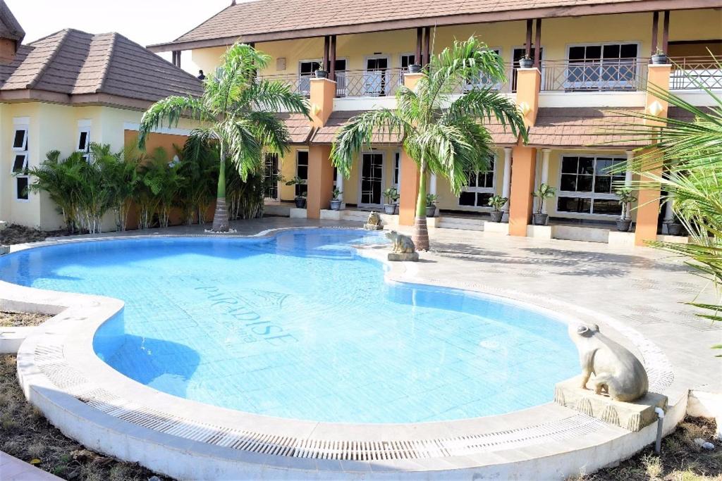 a large swimming pool in front of a building at Paradise Estate in Katamanso