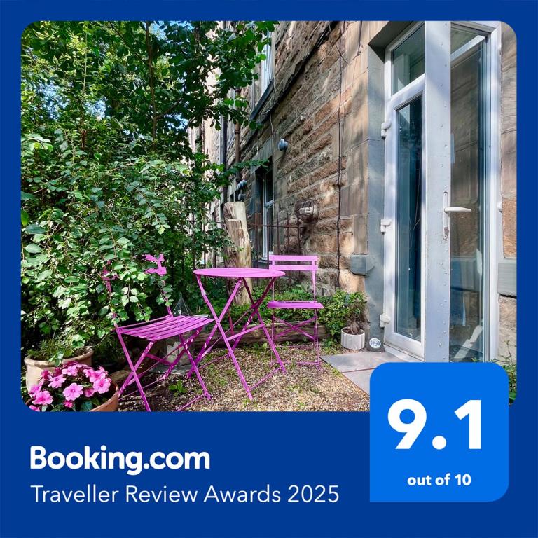 a purple table and chairs sitting in a garden at Garden Flat in Edinburgh