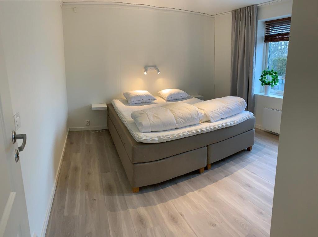 a bedroom with a bed in a room with a window at Newly renovated, near town center in Grebbestad