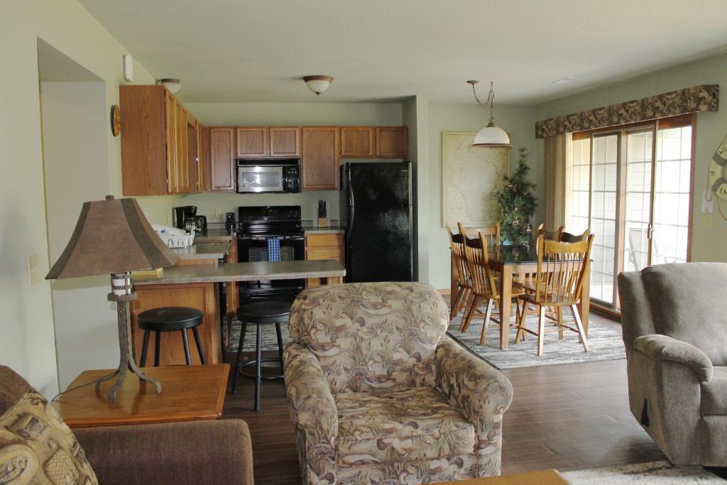 a kitchen and living room with a table and chairs at 2 Bedroom accessible condo in Eagle River