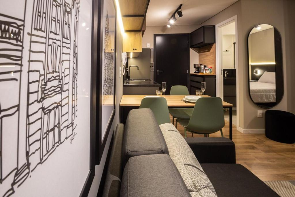 a living room with a couch and a table at Loft 613 Canto com garagem in Pelotas