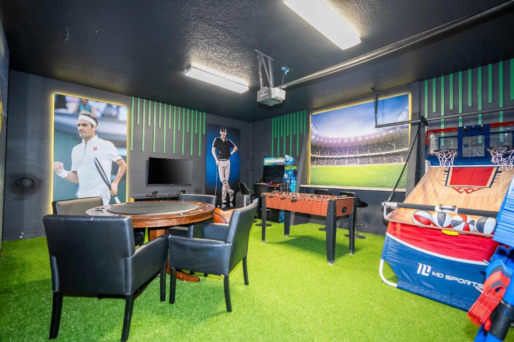 a baseball game room with a table and a tv at 510 BS - 5BD Cozy Family Haven with Pool in Orlando