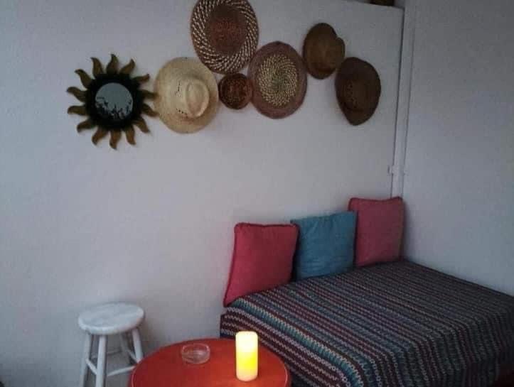 a room with a couch and a table with a candle at Casa do Ocaso in Luz