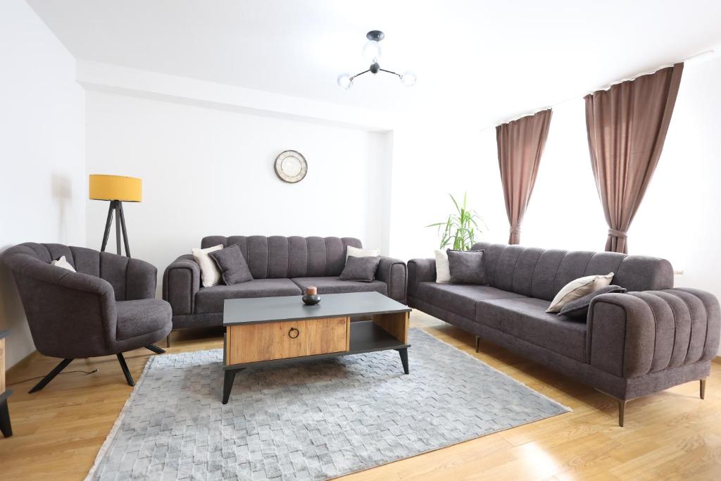 a living room with two couches and a coffee table at Central Prime Apartments 09 in Pristina
