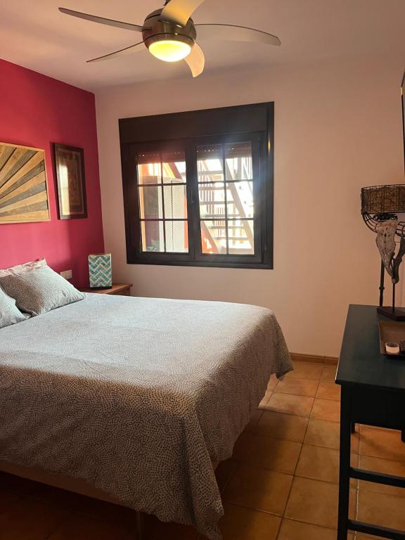 a bedroom with a bed and a window at Casalegre in Cotillo