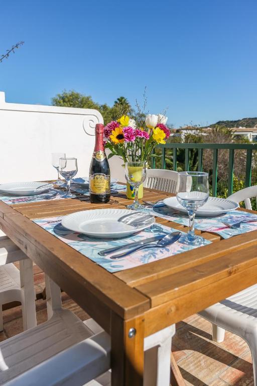 a wooden table with glasses and a bottle of wine at Casa Azure in Luz