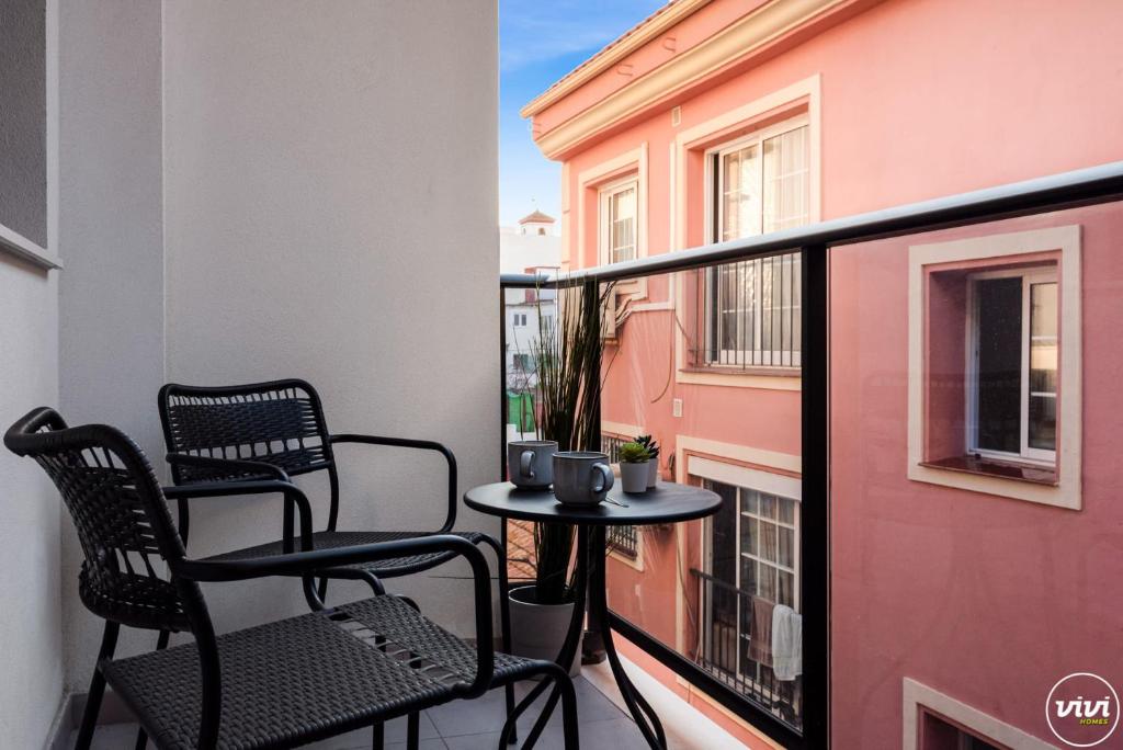 a balcony with two chairs and a table on a balcony at ViVi Homes - Anemona , Beach , Balcony, Centre in Fuengirola