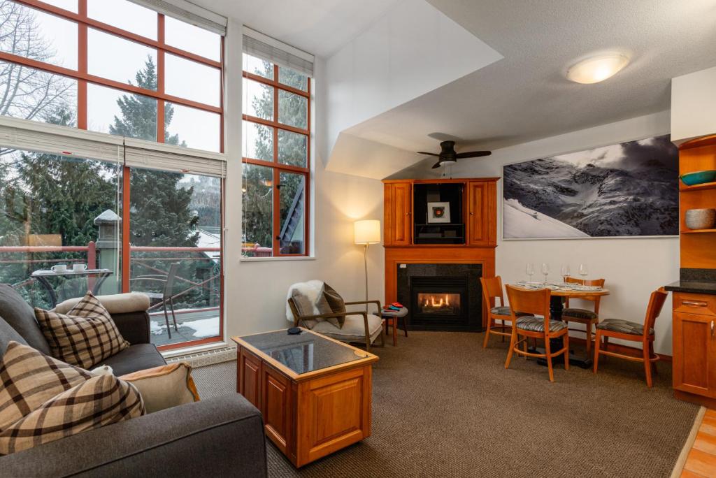 a living room with a couch and a fireplace at Village Penthouse w Views Pool and Hot Tub in Whistler