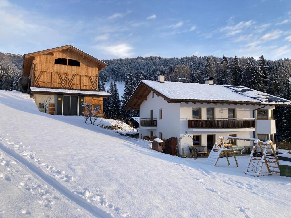 a house in the snow with snow covered ground at Brixlechnerhof in Maranza